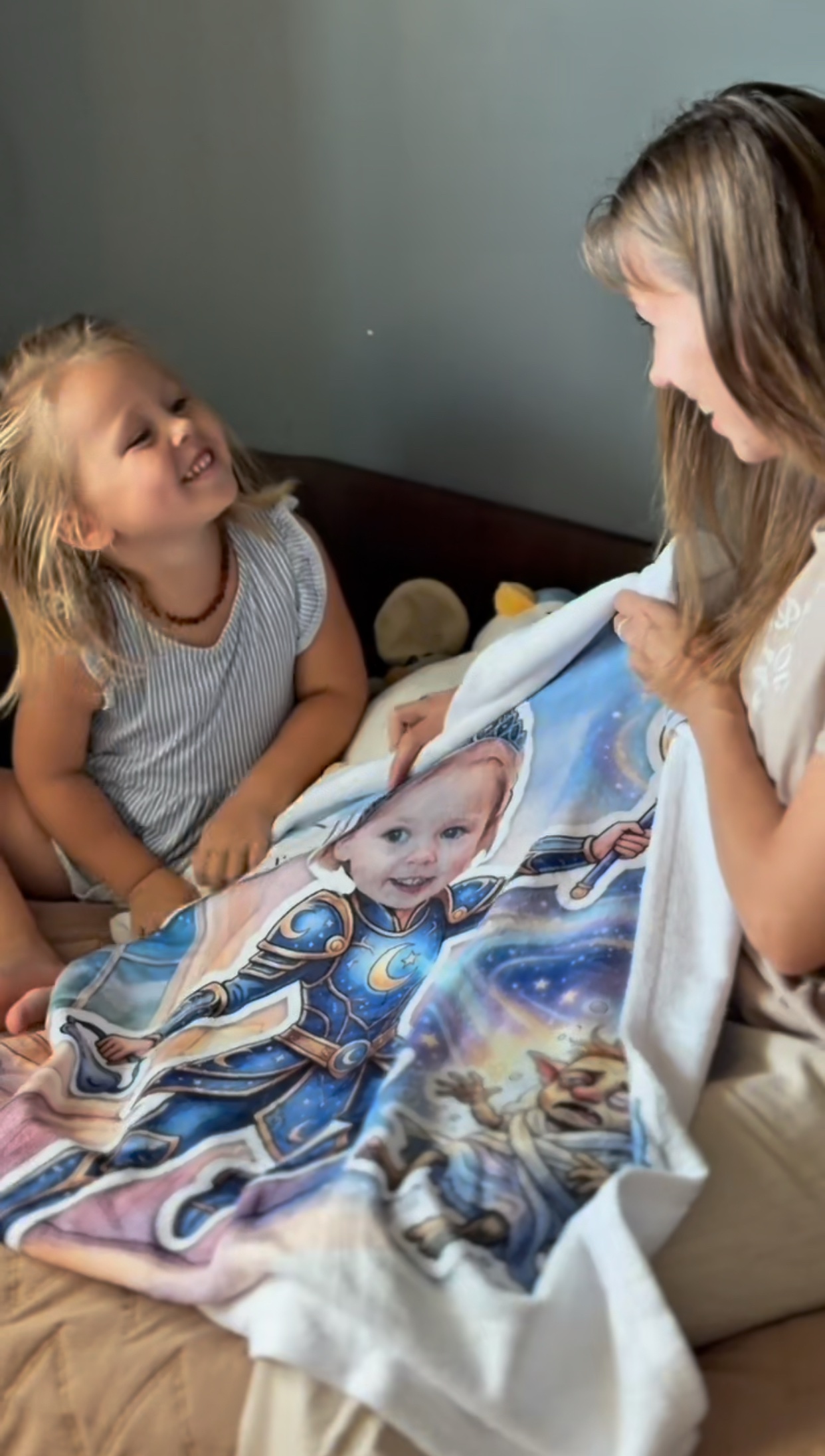 Mom and daughter revealing her Sleep Queen blanket